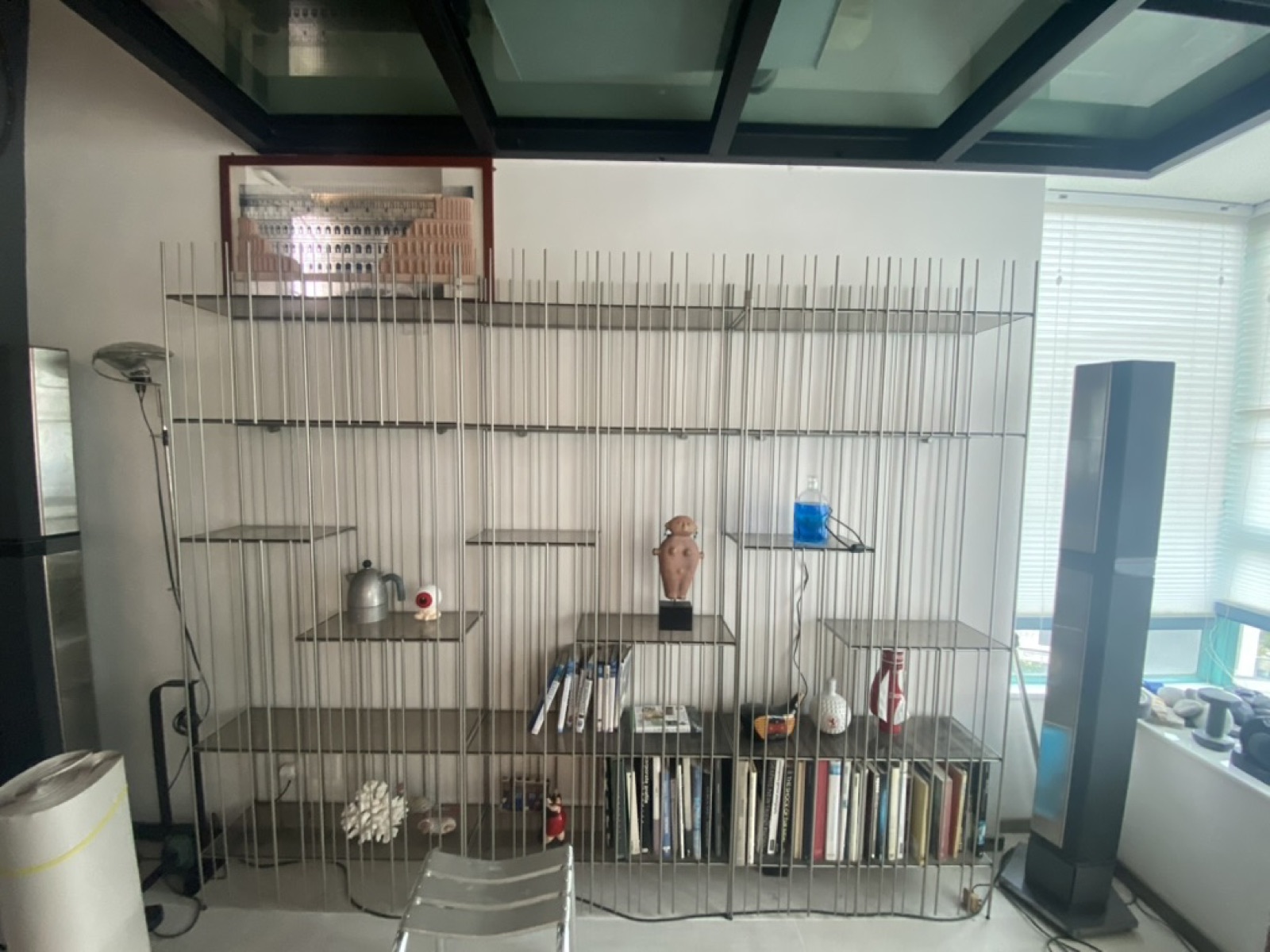 Chrome wire shelving displaying art objects and books